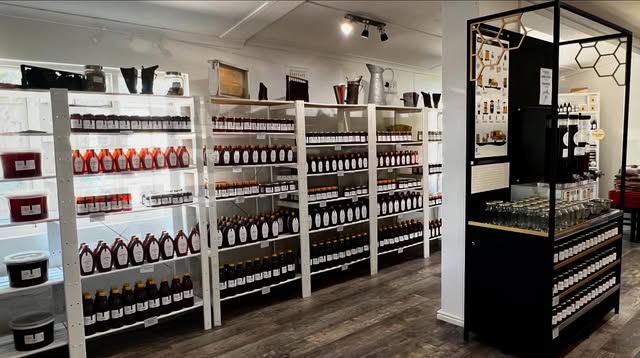 White shelves stocked with VitaBee honey in the shop