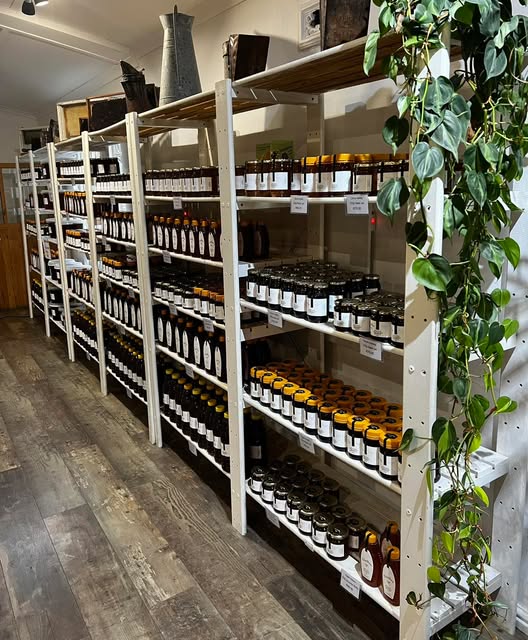 Shelves of honey jars inside the VitaBee farm shop
